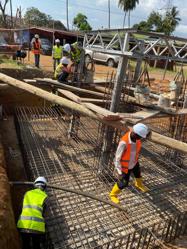 King Sign & Design construction crew working on a reinforced concrete foundation in Liberia